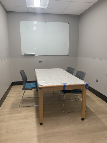 Picture of study room with one table and three chairs.