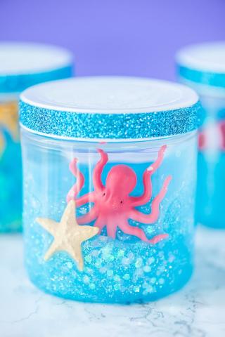 photo of jar with blue glitter slime and ocean themed toys