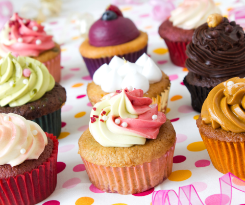 photo of several different cupcakes with different colored icing